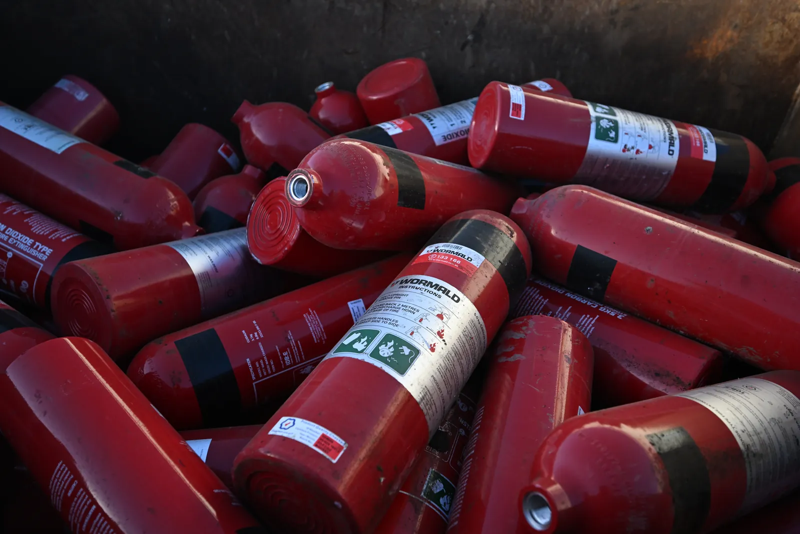 Retired fire extinguishers lined up at CMR, waiting to be processed