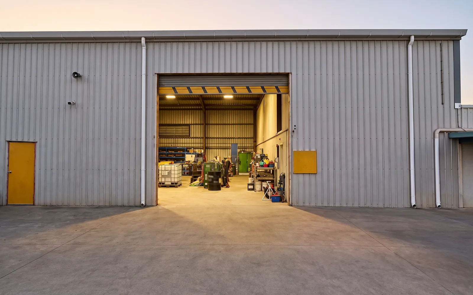 An open shed doorway, lights on inside, nobody there
