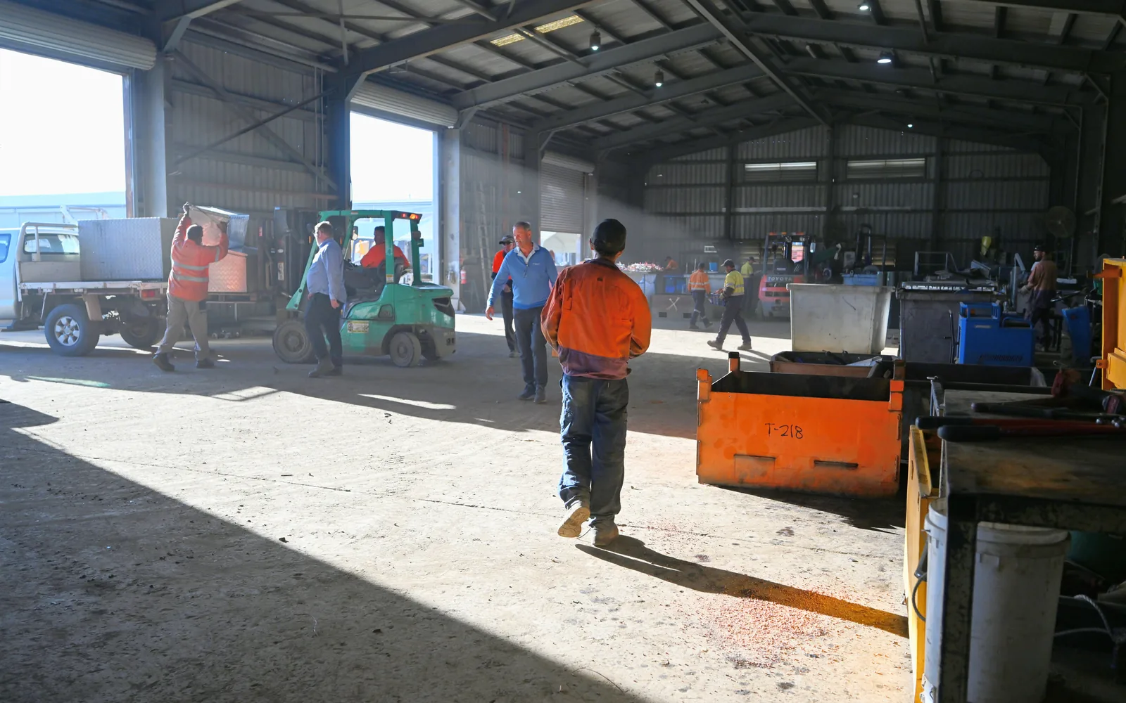 The team at work on the floor of CMR Recycling's main shed, a forklift by the open roller doors
