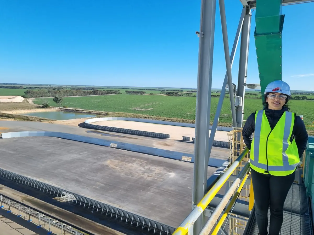 Nikita Gossain in hi-vis and a hard hat on a high walkway at an industrial site