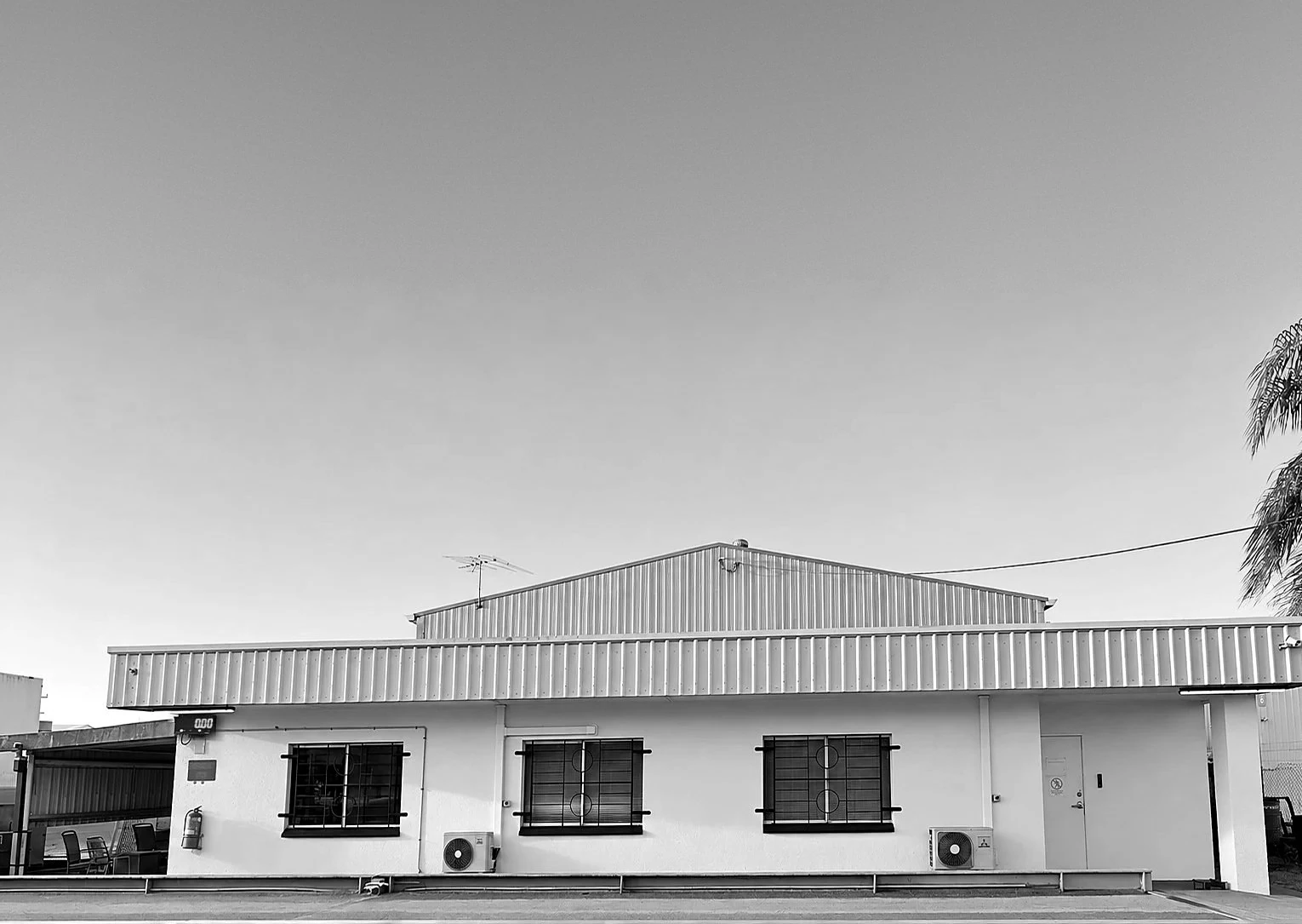 A long established business office and shed, photographed in black and white